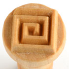 Ceramic texture stamp with a geometric spiral design, ideal for adding detail to pottery and clay projects.