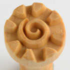 Tan ceramic texture tool with spiral and petal designs, used for decorating clay surfaces in pottery and sculpture projects.