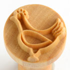 Ceramic stamp featuring a detailed chicken design, ideal for decorating pottery and clay projects with unique impressions.