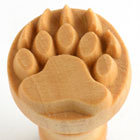 Wooden paw print stamp for decorating clay and ceramics, featuring detailed claw impressions for unique pottery designs.