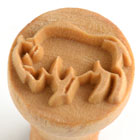 Carved wooden stamp featuring a decorative design, ideal for imprinting on clay and pottery surfaces.