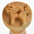 Stamp tool featuring a carved animal design, used for decoration in pottery and clay projects. Ideal for ceramic art.