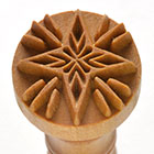 Floral-patterned ceramic stamp tool made from soft clay, ideal for decorating pottery and sculptural projects at Georgies.