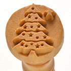 Ceramic stamp featuring a carved Christmas tree design, ideal for decorating pottery or clay projects during the holiday season.