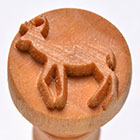 Wooden pottery tool with carved deer design, ideal for imprinting on clay for decorative ceramics and sculpture work.