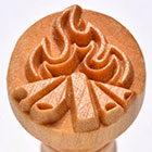 Wooden pottery stamp featuring a flame design, used for decorating ceramics and pottery surfaces.