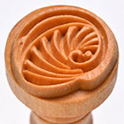 Wooden pottery stamp featuring a detailed spiral leaf design, ideal for decorating clay and ceramics at Georgies Ceramic & Clay Company.