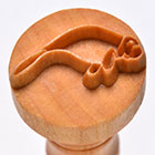 Wooden clay stamping tool featuring a wave design, ideal for adding texture to pottery and ceramic decorating projects.