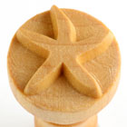 Wooden stamp with a starfish design used for decorating clay pottery at Georgies Ceramic & Clay Company.