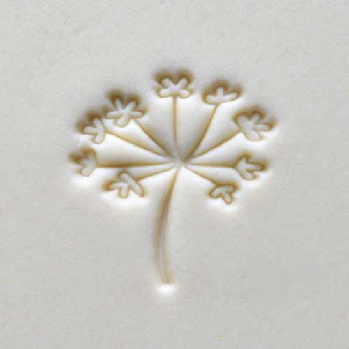 Embossed floral design on white clay, ideal for ceramic decoration and sculptural techniques in pottery.