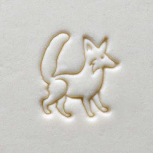 Embossed fox design on a white clay surface, showcasing texture for decorative pottery or ceramic projects.