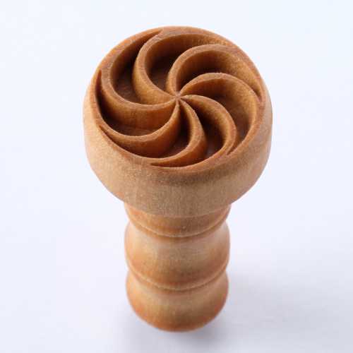 Wooden carving tool for decorative pottery, featuring a spiral design, ideal for enhancing ceramic surfaces and texture.