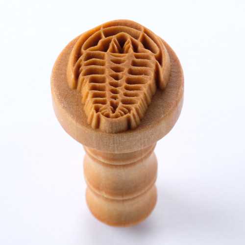 Ceramic texture tool shaped like a trilobite for pottery decorating, made from durable rubber for intricate designs.