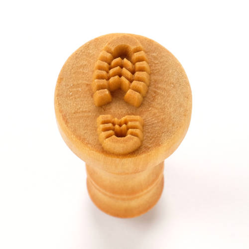 Wooden texture stamp featuring a shoe print design, ideal for creating unique surface textures on clay pottery.