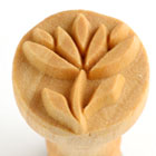 Wooden stamp featuring a carved leaf design, used for decorating clay and ceramics at Georgie's Ceramic & Clay Company.