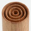 Close-up of a textured wooden ceramic roller for creating decorative patterns on clay surfaces.