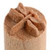 Close-up of a ceramic texture stamp with a floral design, used for decorating clay surfaces in pottery.