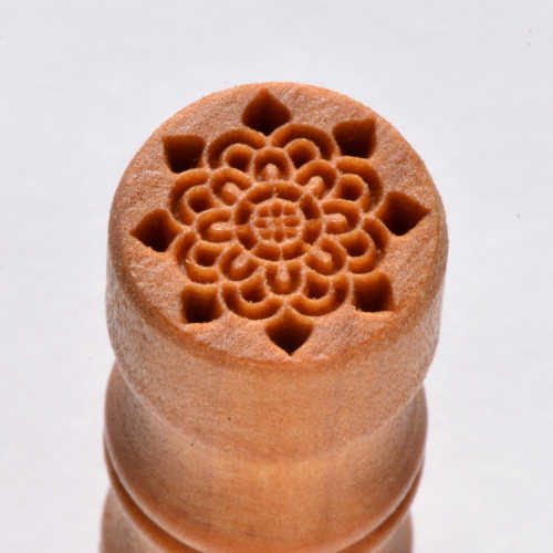 Ceramic texture stamp featuring a detailed flower design, ideal for embellishing pottery or clay projects.