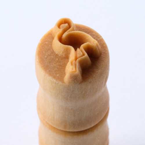 Ceramic sculpting tool with a delicate spiral design, used for detailing and decorating clay pottery and sculptures.