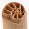 Detailed image of a textured wooden ceramic stamp, ideal for adding unique patterns to pottery or clay projects.