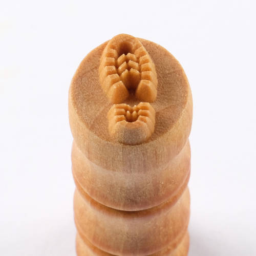 Stack of four clay stamps with textured designs for pottery, ideal for creating intricate patterns and details in ceramics.