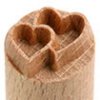 Heart-shaped clay stamp used for decorating pottery, crafted from wood for precise impressions in ceramics.