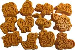 A collection of orange rubber stamps featuring various animal designs for decorating pottery and clay projects.