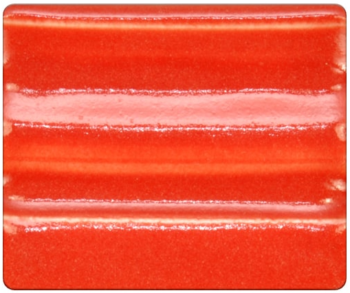 Bright red ceramic glaze sample with glossy surface and subtle texture, showcasing color variation and depth for pottery projects.