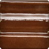Dark brown ceramic glaze sample with glossy white streaks, showcasing a unique decorative finish for pottery projects.