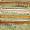 Textured clay glaze sample featuring layers of green, beige, and orange hues, demonstrating ceramic decoration techniques.