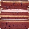 Close-up of a rich, red-brown ceramic glaze with subtle speckles, ideal for pottery decoration and unique finishes.