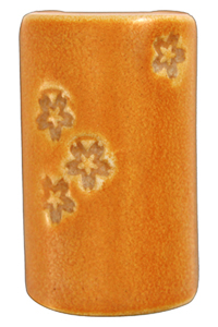 Ceramic vase with a glossy orange glaze, featuring carved floral patterns on one side, showcasing crafting techniques.