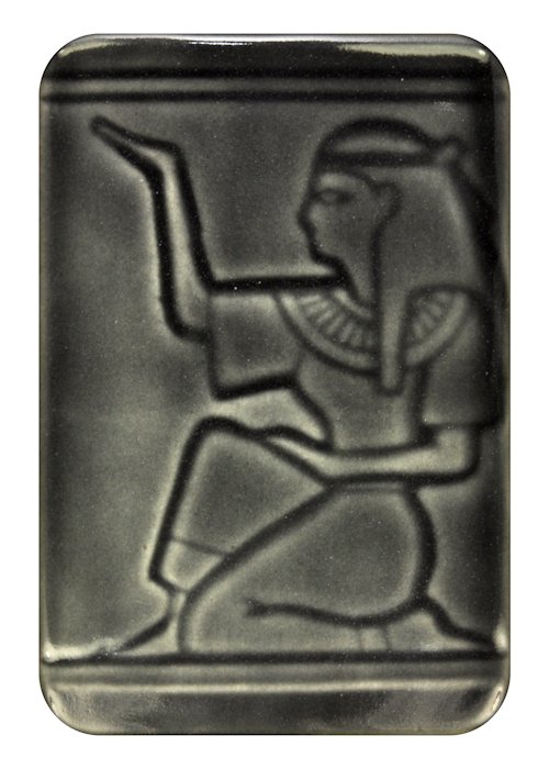 Black ceramic tile featuring an Egyptian figure in relief, kneeling and gesturing, ideal for decorative applications.