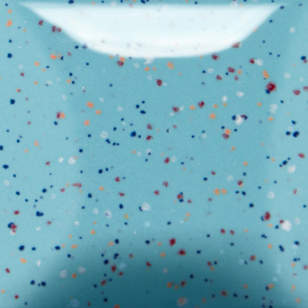 Speckled blue ceramic glaze sample with blue, orange, and red flecks, ideal for pottery decoration and artistic finishes.