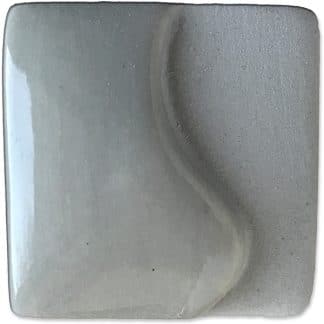 Gray ceramic glaze sample with a wavy texture, showcasing a smooth finish ideal for pottery decoration and firing.