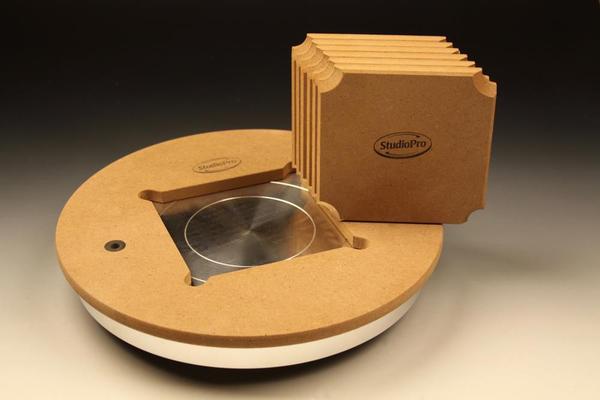 StudioPro pottery wheel with MDF body and metal platform, accompanied by ceramic tool sets for shaping and decorating.