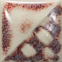 Ceramic test tile featuring glossy white glaze with red speckling and a textured surface showing geometric patterns.