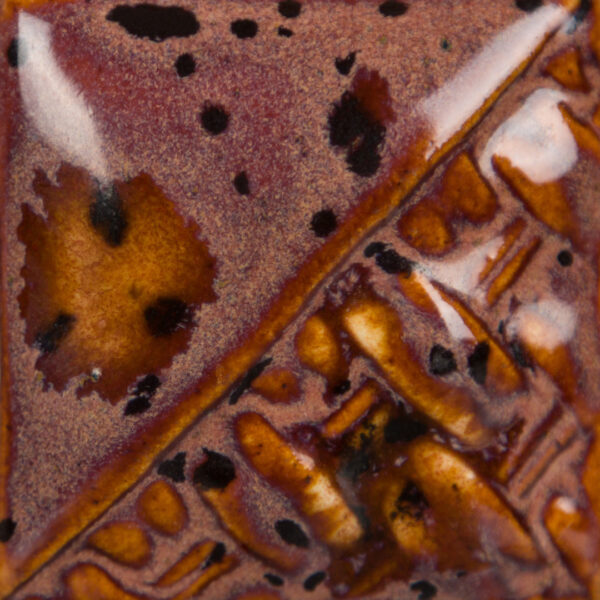 Close-up of a ceramic glaze sample featuring rich, brown and copper tones with textured, patterned surface detail.
