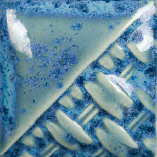 Celadon pottery glaze with blue floral textures and patterns, showcasing a smooth, glossy finish and artistic design.