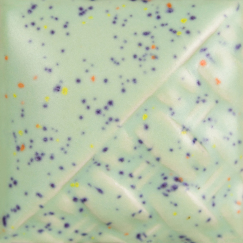 A close-up of a light blue ceramic glaze with dark purple and yellow speckles, showcasing decorative texture patterns.