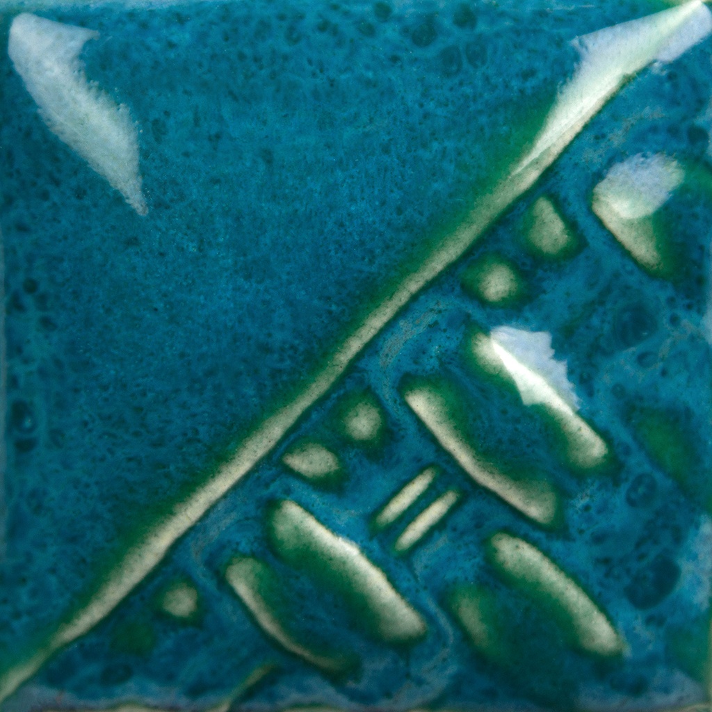 Textured ceramic tile featuring a vibrant turquoise glaze with green accents, showcasing glazing techniques and color variation.