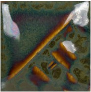 Ceramic tile showing a lustrous green-brown glaze with metallic accents and textured surfaces, ideal for decorative pottery.
