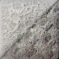Textured ceramic surface showing a speckled grey finish, ideal for creating unique pottery pieces or decorative tiles.