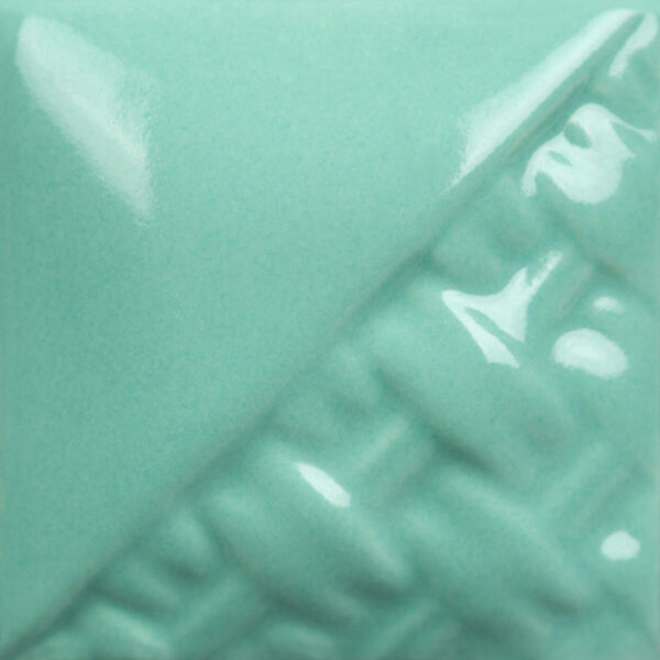Glossy teal glaze sample on textured clay, showcasing vibrant color and finish for ceramics or pottery applications.