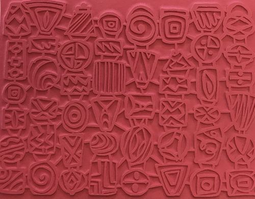 Textured red rubber stamp with various geometric and abstract designs, used for decorating pottery and ceramics.