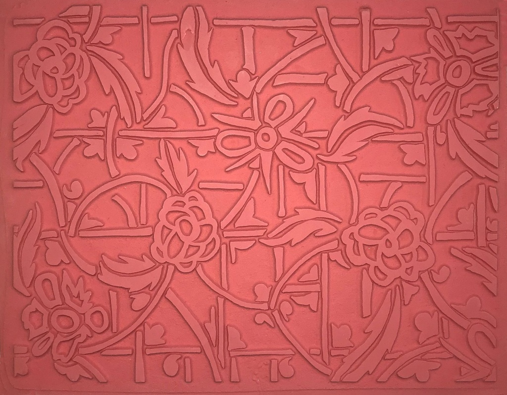 Textured pink clay slab featuring floral designs, suitable for pottery decoration and sculptural applications.