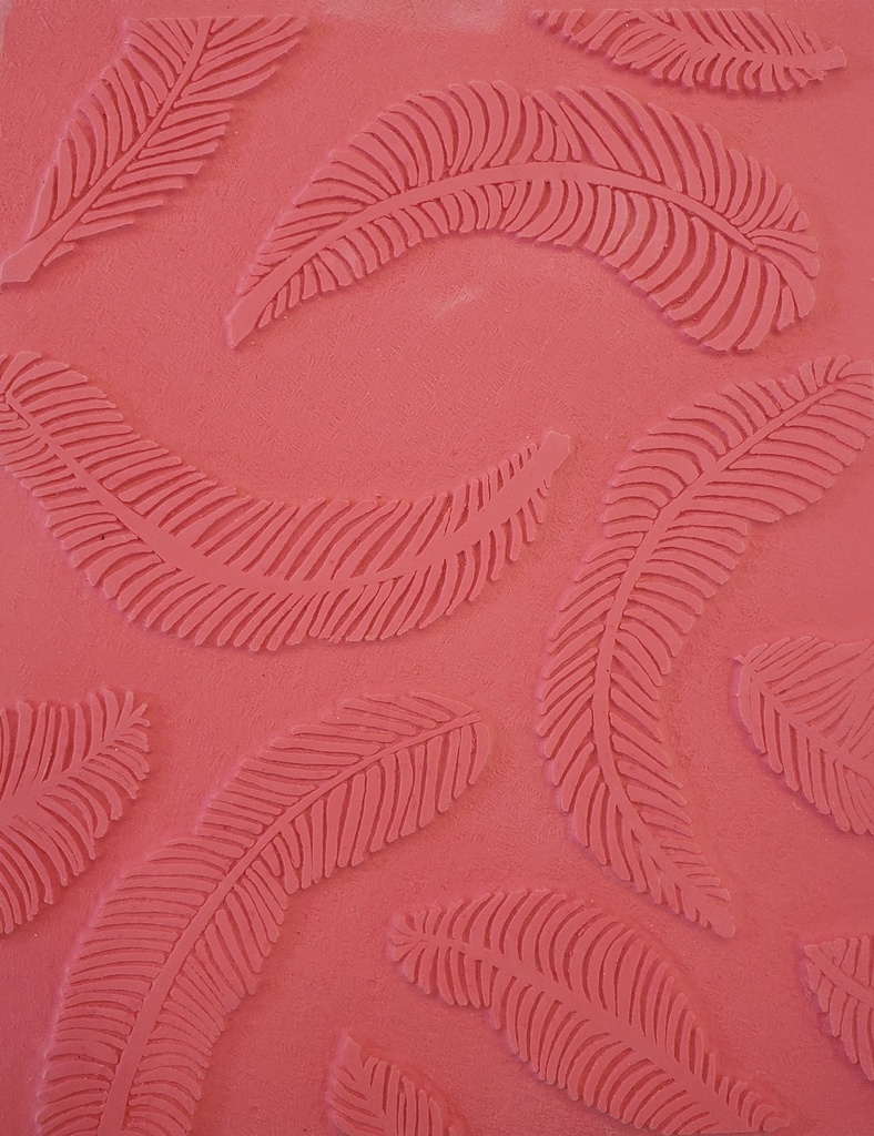 Pink clay textured with leaf imprints, showcasing detailing for ceramic decoration techniques at Georgies Ceramic & Clay Company.