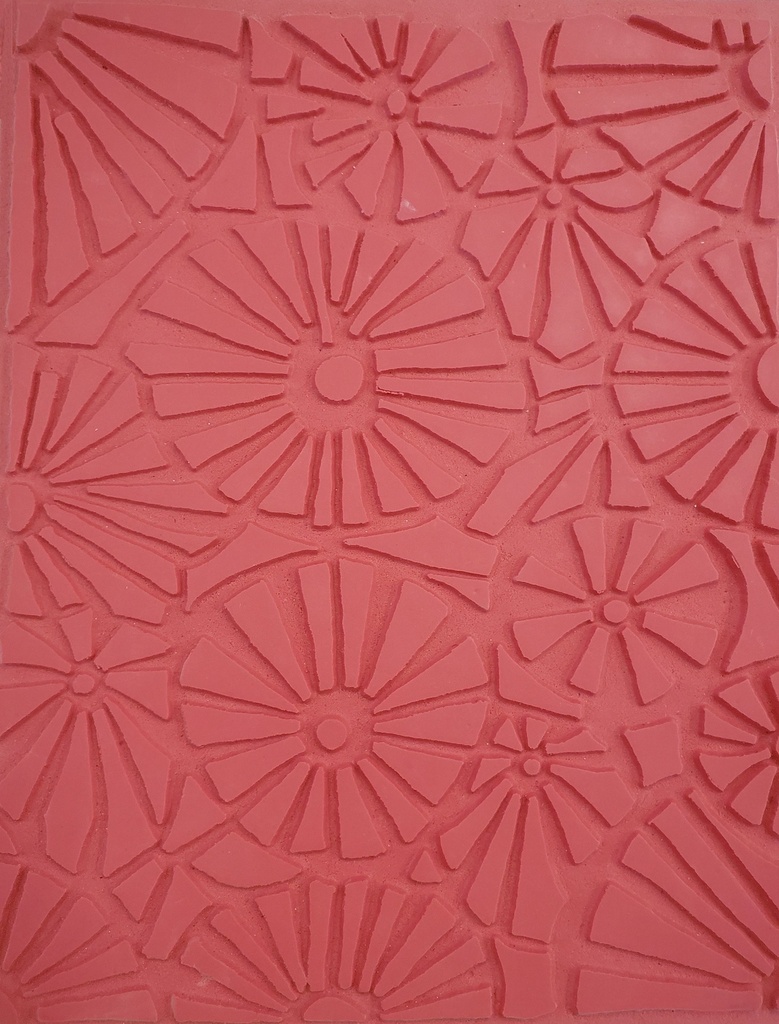 Textured pink clay slab with floral patterns, ideal for ceramics decoration, sculpting, or pressing into molds.