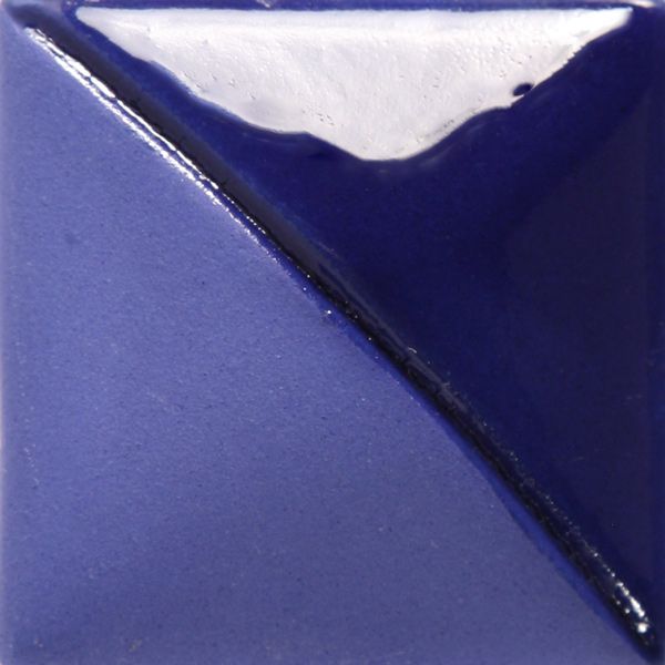 A glossy blue and white ceramic tile displaying a diagonal split, showcasing vibrant glaze techniques used in pottery.