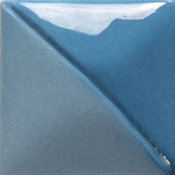 Ceramic tile displaying a split design in matte and glossy blue glazes, showcasing smooth texture and color contrast.